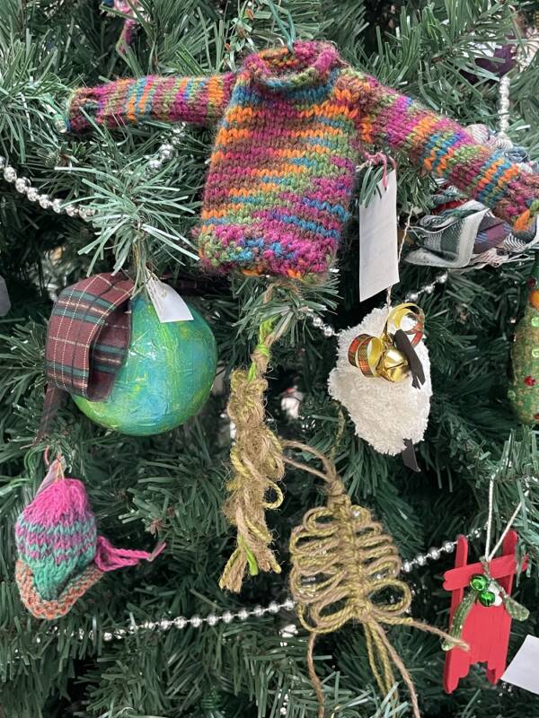 Festive ornaments hanging from tree.