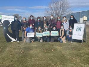 Photo showing Five Counties and EarlyON staff promoting support for backyard project in Northumberland.