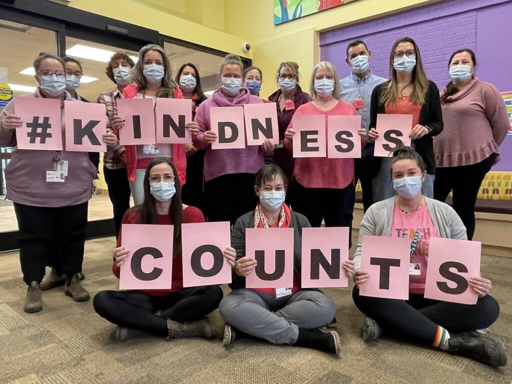 Five Counties staff holding up sign reading, 'Kindness Counts.'